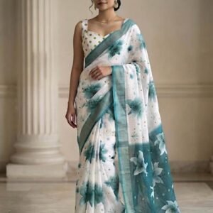 linen saree featuring a deep teal border and a matching sleeveless, square-neck blouse with a white-and-gold polka dot pattern.