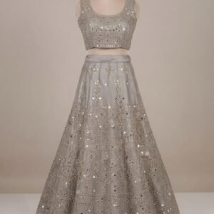 Front view of a bridal mannequin dressed in a Silver gray lehenga with intricate silver thread work, scoop-neck blouse, and traditional heavily embellished skirt