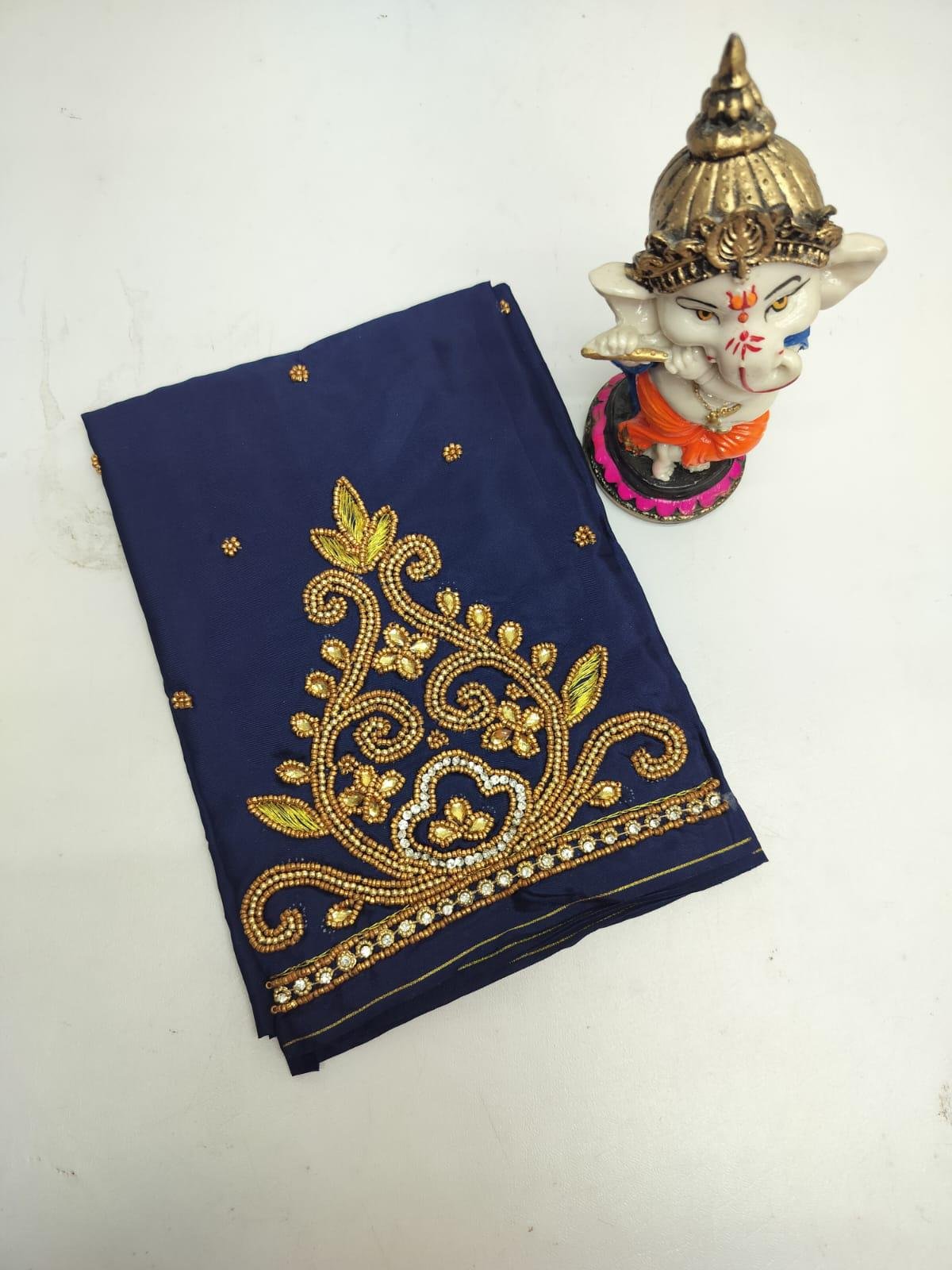 Detailed Aari embroidery work on blouse sleeve material